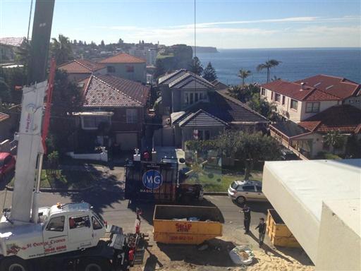 Crane lift glass onto roof